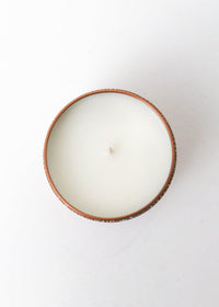 Capri Blue Gilded Muse Dark Vanilla and Sandlewood Tin Candle-Hand In Pocket